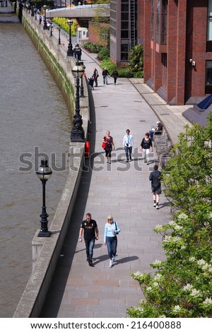 LONDON, UK - MAY 13, 2012: Tourists visit Thames Embankment in London. With more than 14 million international arrivals in 2009, London is the most visited city in the world (Euromonitor).