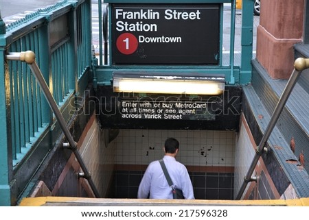 NEW YORK, USA - JULY 1, 2013: Person enters subway station in New York. With 1.67 billion annual rides, New York City Subway is the 7th busiest metro system in the world.