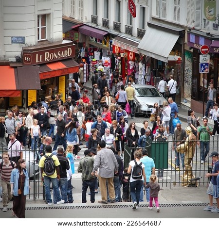 PARIS, FRANCE - JULY 22, 2011: Tourists stroll in Montmartre district in Paris, France.  Paris is the most visited city in the world with 15.6 million international arrivals in 2011.