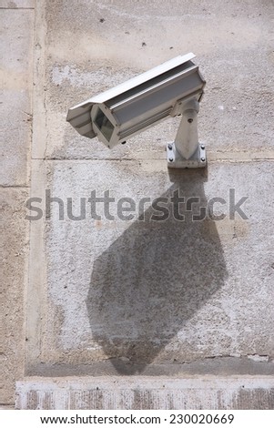 Surveillance camera in the city - electronic security technology.