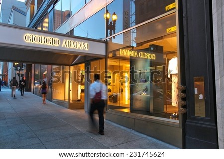 SAN FRANCISCO, USA - APRIL 8, 2014: People walk by Giorgio Armani fashion store in San Francisco. The famous fashion company had 1.8 billion EUR worldwide revenue in 2011.