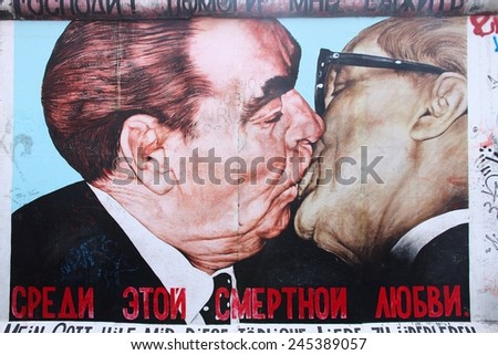 BERLIN, GERMANY - AUGUST 26, 2014: Urban art of East Side Gallery seen from public street in Berlin. Part of former Berlin Wall is covered in art by more than 100 artists since 1990.