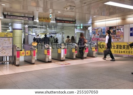 TOKYO, JAPAN - APRIL 13, 2012: People enter Toei Metro in Tokyo. With more than 3.1 billion annual passenger rides, Tokyo subway system is the busiest worldwide.