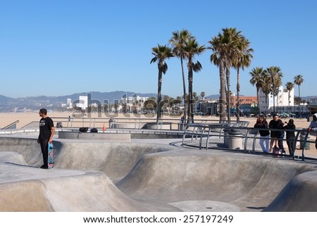 VENICE, UNITED STATES - APRIL 6, 2014: People visit skate park at Venice Beach, California. Venice Beach is one of most popular beaches of LA County. 9.8 million people live in LA County.
