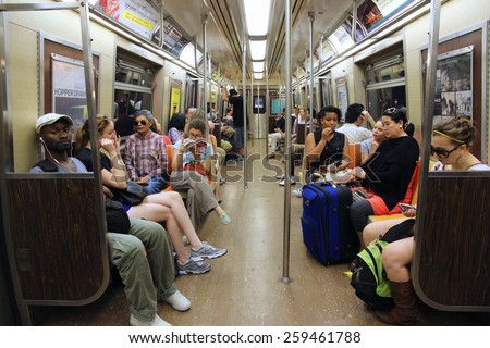 NEW YORK, USA - JULY 4, 2013: People ride Subway train in New York. With 1.67 billion annual rides, New York City Subway is the 7th busiest metro system in the world.