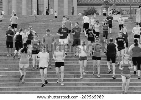 PHILADELPHIA, USA - JUNE 11, 2013: People run down famous Rocky Steps in Philadelphia. The steps were made famous by the film \