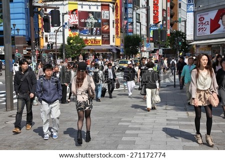 TOKYO, JAPAN - MAY 11, 2012: People walk in Shinjuku district of Tokyo. Tokyo is the capital city of Japan and the most populous metropolitan area in the world with almost 36 million people.