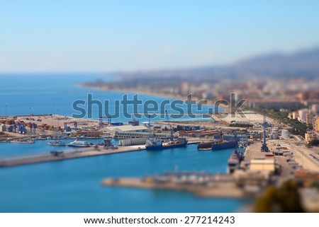 Malaga in Andalusia, Spain. Aerial view of port and the city. Tilt shift style focus with defocused background.