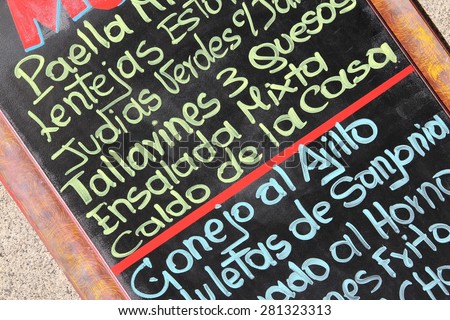 Restaurant menu with typical Spanish cuisine - outdoor bar in Madrid, Spain. Generic dish names.