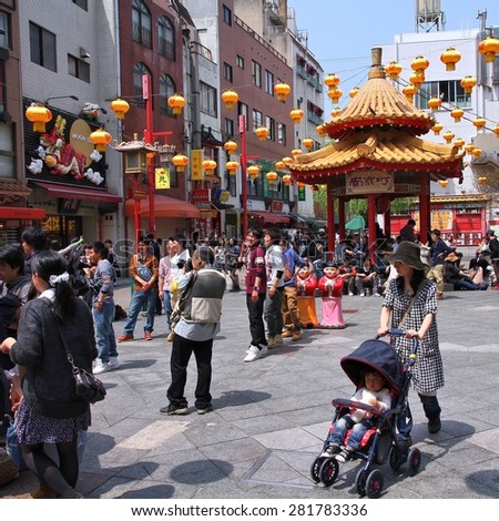 KOBE, JAPAN - APRIL 24, 2012: Visitors enjoy sunny weather in Chinatown in Kobe, Japan. Nankinmachi, Kobe\'s Chinatown is the 2nd largest in Japan and a popular tourism attraction.