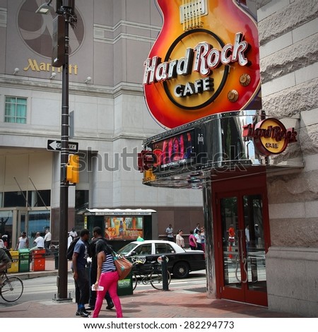 PHILADELPHIA, USA - JUNE 11, 2013: People walk past Hard Rock Cafe in Philadelphia. There are 175 Hard Rock locations in 53 countries.