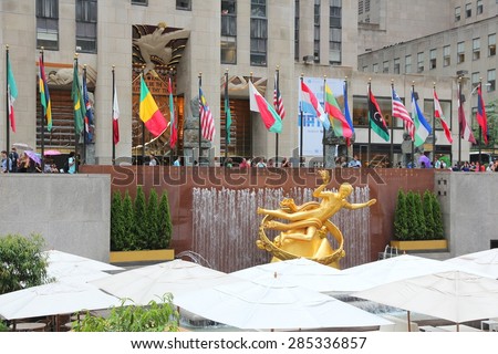 NEW YORK, USA - JULY 1, 2013: People visit Rockefeller Center in New York. Rockefeller Center is one of most recognized landmarks in the United States and is a National Historic Landmark.