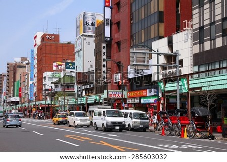 TOKYO, JAPAN - APRIL 13, 2012: People drive in Asakusa district, Tokyo. Asakusa is one of the oldest districts of Tokyo, capital city and largest urban area of Japan (35 million people in metro area).