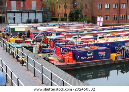BIRMINGHAM, UK - APRIL 24, 2013: Narrowboats moored at Gas Street Basin in Birmingham, UK. Birmingham is the 2nd most populous British city. It has rich waterway and boat culture.