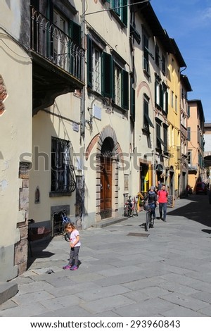FLORENCE, ITALY - APRIL 29, 2015: People visit Old Town street in Lucca, Italy. Italy is visited by 47.7 million tourists a year (2013).