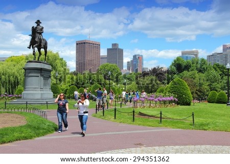 BOSTON, USA - JUNE 9, 2013: People visit Washington Monument at Public Garden in Boston. Public Garden dates back to 1837 and is a registered monument.