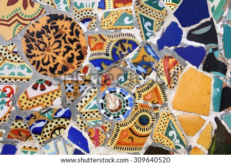 BARCELONA, SPAIN - SEPTEMBER 13, 2009: Mosaics in Park Guell in Barcelona, Spain. The landmark was built in 1900-14 and is part of the UNESCO World Heritage Site \