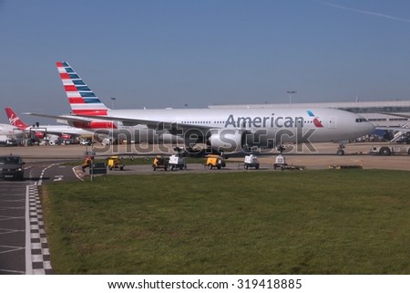 LONDON, UK - APRIL 16, 2014: American Airlines Boeing 777 at London Heathrow airport. Oneworld alliance (which includes AA) carries more than 500 million passengers annually.