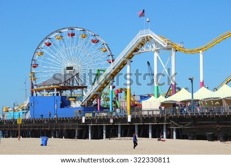 SANTA MONICA, UNITED STATES - APRIL 6, 2014: People visit beach in Santa Monica, California. As of 2012 more than 7 million visitors from outside of LA county visited Santa Monica annually.
