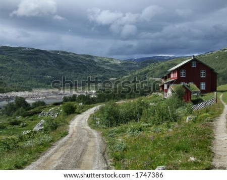 House in mountains - Norway. Cloudy weather and a nice, brown, typical Norwegian wooden house.