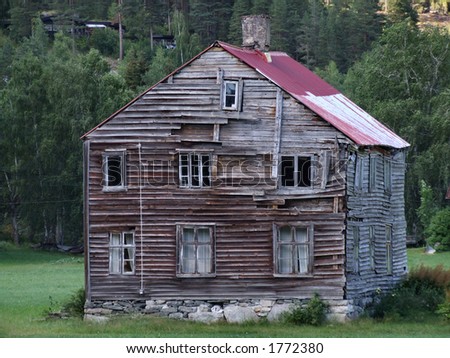 Old abandoned wooden house. A house in a Norwegian village. Apparently abandoned and left to ruin.