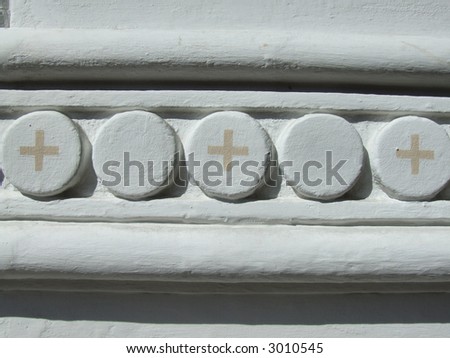 Religious architecture detail. White wall and crosses.