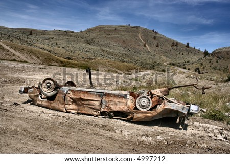 Crashed, rusty car in desert. Photo taken near Kamloops, British Columbia, Canada (North America).