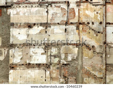 Ruined wall surface after demolition of a part of an old tenement in Milan, Italy. Bricks, stairs, paint.
