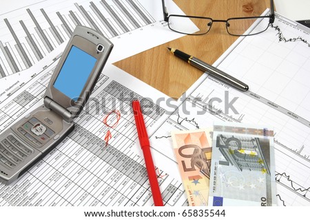 Business composition. Financial analysis - income statement, finance charts, red marker, Euro money and a mobile phone.