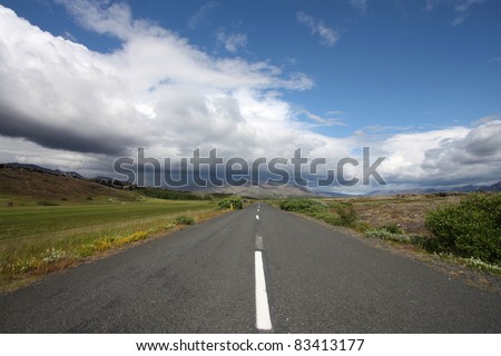 Cloudy weather. Road in Thingvellir National Park - famous area in Iceland.