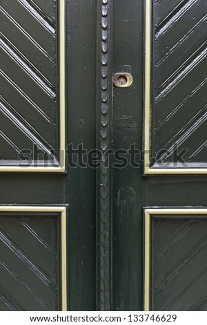 Former Victorian green door, detail of an old door on the street, with gold decoration