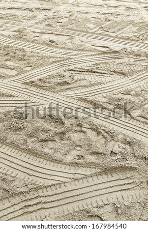 Wheel tracks in the sand, detail of car brands in the sand, sign and mark, indication