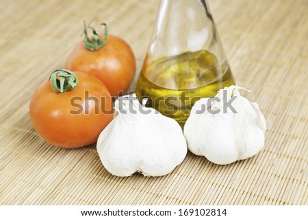 Raw garlic with tomatoes and olive oil, detail from food healthy lifestyle, mediterranean diet, diet and healthy lifestyle
