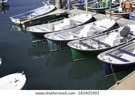 Boats moored at a marine dock, detail of recreational boats on a dock, fishing and fun, sea transport