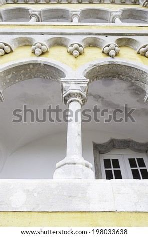 Ancient yellow arches in the Pena Palace, detail of ancient architecture, heritage of humanity, tourism