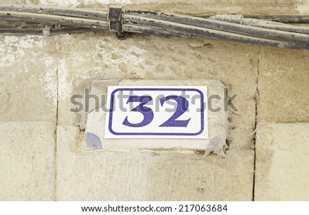 Number thirty-two on the wall of a house, number of information, even number