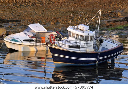 Two boats in a port of brittany in france in light of sunset