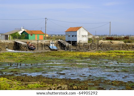 Saint Trojan Oleron in France, region oyster, at low tide, with fishermen huts in the background. Department Charente Maritime. Poitou-Charentes region