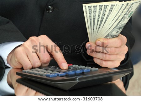 calculator and money in hand of businessnan