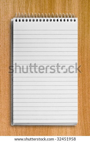 blank background. paper spiral notebook over wood