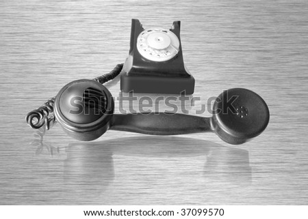 old telephone receiver with retro phone with reflection
