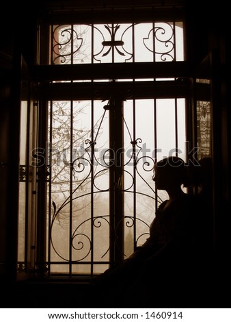 woman silhouette by the window