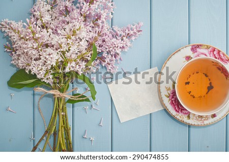 Love card, summer bouquet of beautiful blooming lilac and english black tea in china teacup with saucer