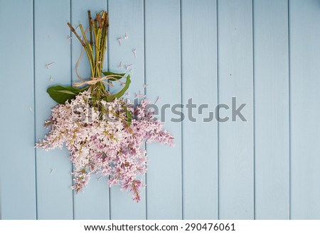Summer bouquet of lilac on the old blue wooden background