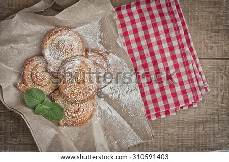 Homemade bakery, puff cookies with sesame seeds on gingham table cloth