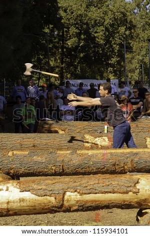 WEST POINT, CA - OCTOBER 6: Unidentified male & female competitors in the axe throwing event at the Lumberjack day, on October 6, 2012 in West Point. West Point celebrates it\'s 38th Lumberjack day.