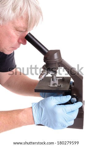 researcher looking through an old microscope isolated on white