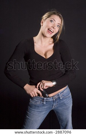 Sexy blond in sweater and jeans with semi-automatic handgun