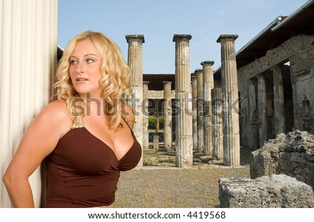 Blond woman leaning against greek style column in the roman city of Pompeii