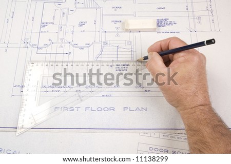 Architect changing drawing of plans for a house